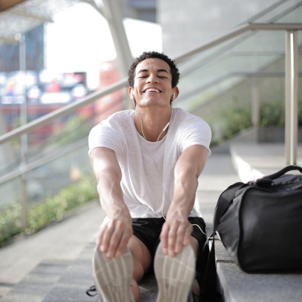 Man stretching outdoors feeling energized and content.
